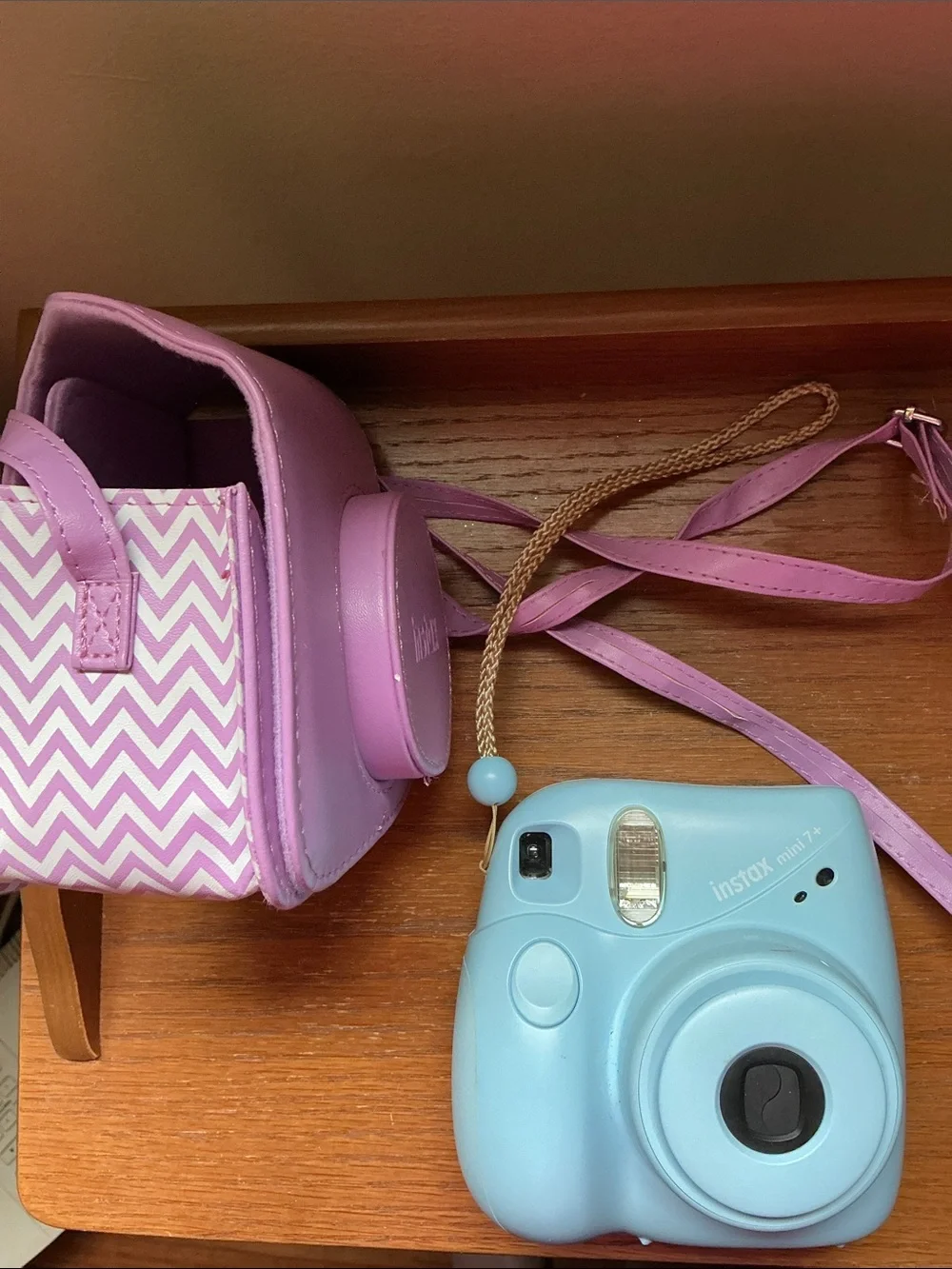 Instax Mini instant camera in light blue with pink carrying case